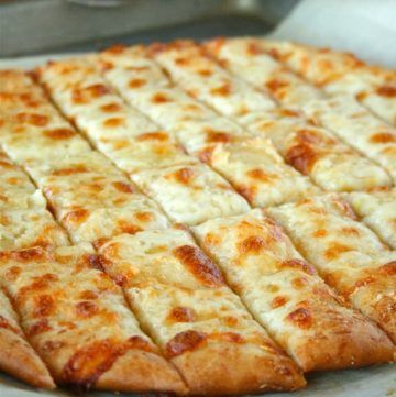 the pizza is cut into squares and ready to be served