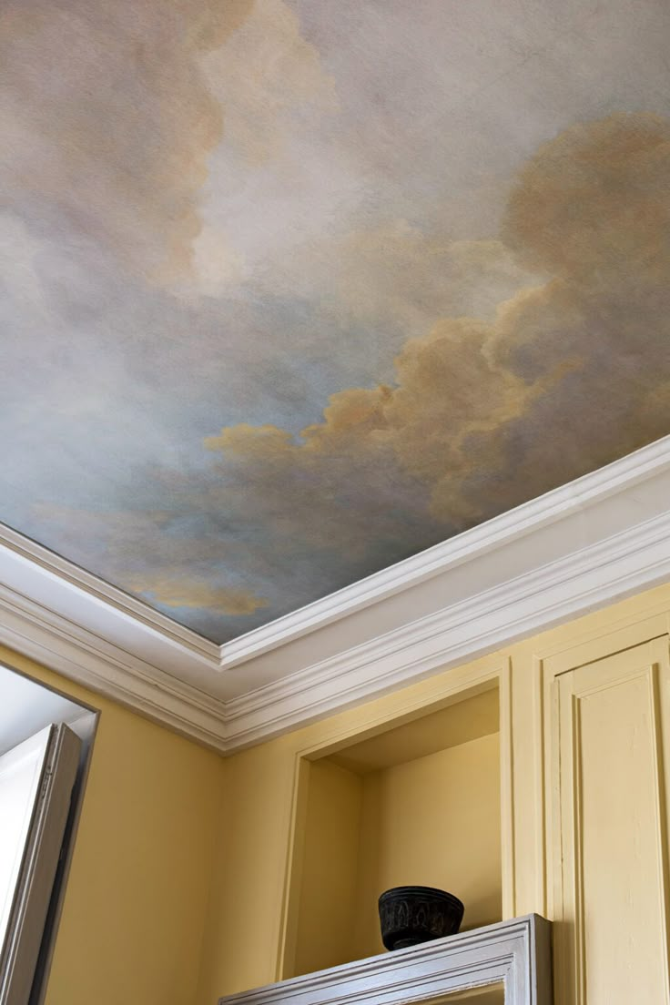 the ceiling is painted with a sky painting on it