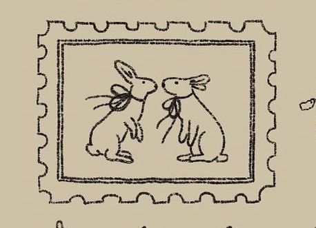 a stamp with an image of two rabbits on it and the words love is in the air