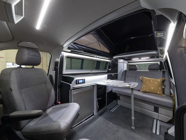 an interior view of a vehicle with grey seats and gray counter tops, including the center console