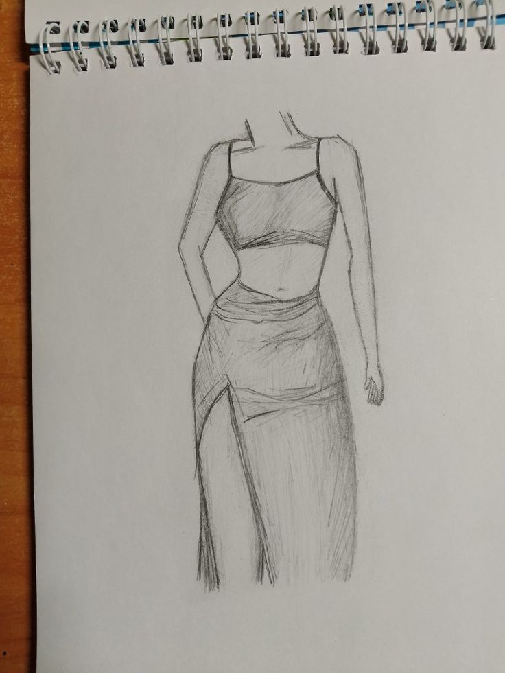 a pencil drawing of a woman's torso and dress on a piece of paper