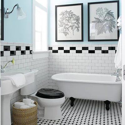 a bathroom with black and white checkered flooring, two pictures on the wall