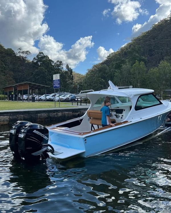 a small blue and white boat in the water