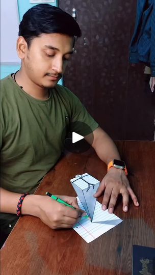 a man sitting at a table with a piece of paper in front of him