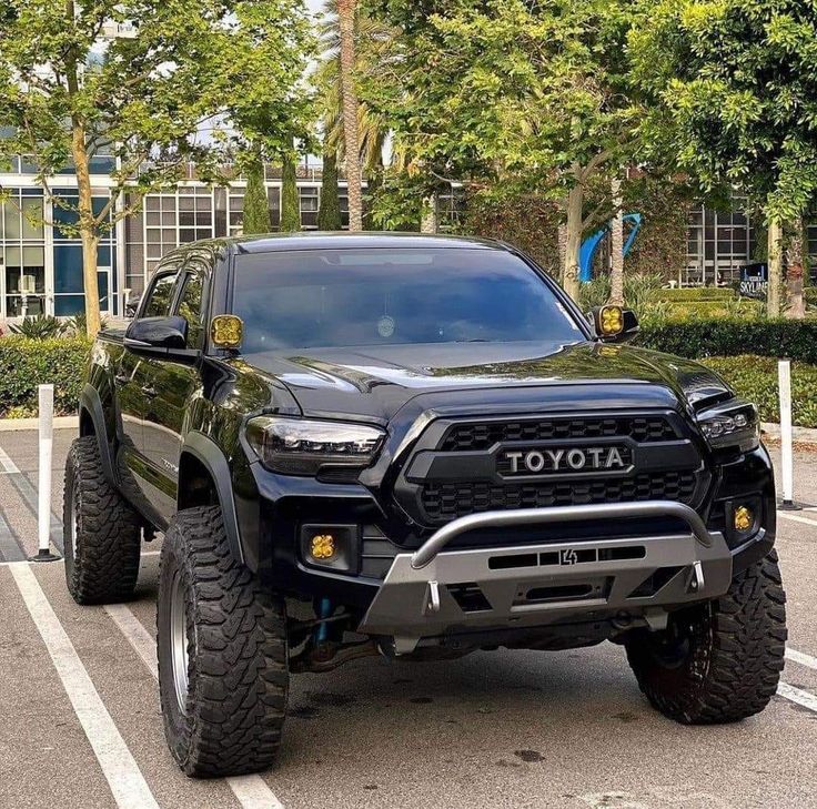 a black toyota truck parked in a parking lot