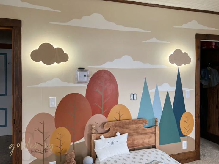 a child's bedroom decorated with trees and clouds