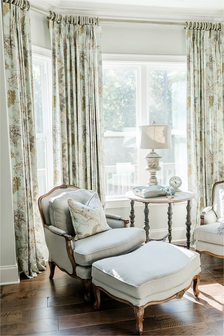 a chair and ottoman in front of a window