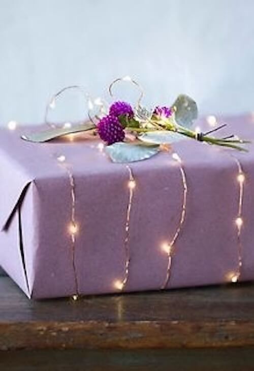 a purple present box with lights on it