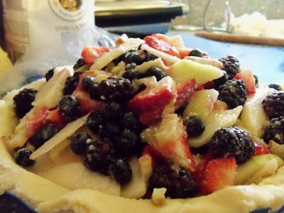 a pie topped with fruit on top of a blue plate