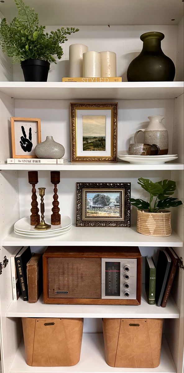 the shelves are filled with books, vases and other decorative items such as plants