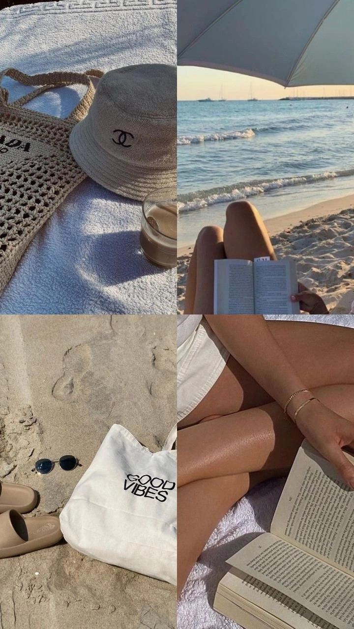 a woman laying on top of a beach next to an open book and white umbrella