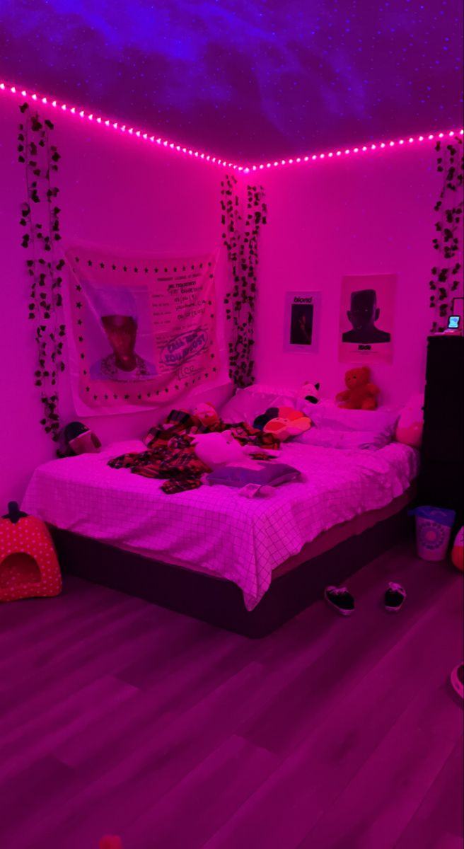 a bed room with a neatly made bed and purple lights on the wall above it