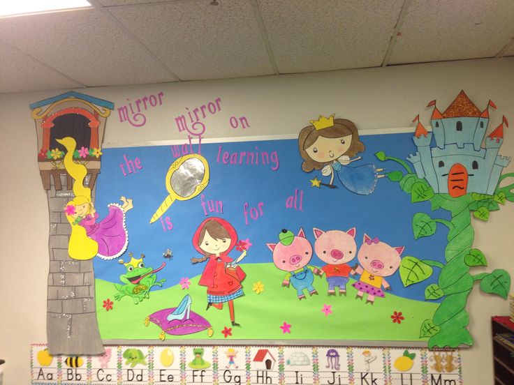 a bulletin board with children's artwork on it in a school classroom setting,