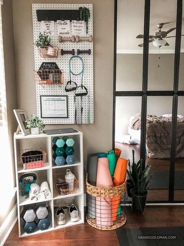 a room with a mirror, shelves and various items on the wall next to it