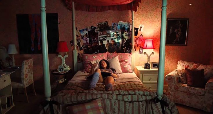 a woman laying on top of a bed in a bedroom