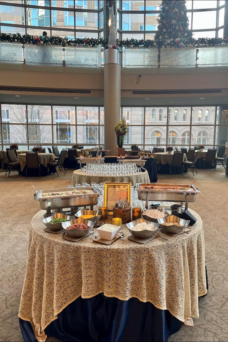 a round table with food on it in a large room