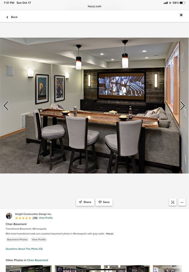 a screen shot of a home theater with chairs and a table in front of it