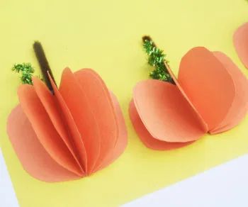 three pieces of paper are arranged in the shape of pumpkins with leaves on them