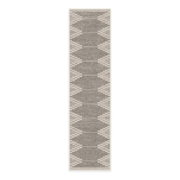 a gray and white runner rug on a white background with an arrow design in the middle