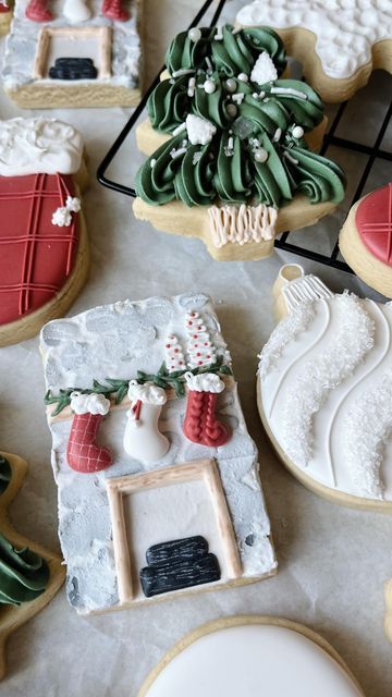 decorated cookies are sitting on a table next to other holiday themed cookies and pastries