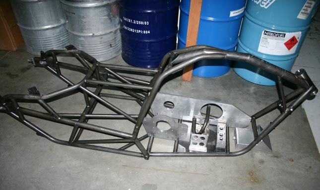 the front end of a race car with metal bars and springs on it's sides