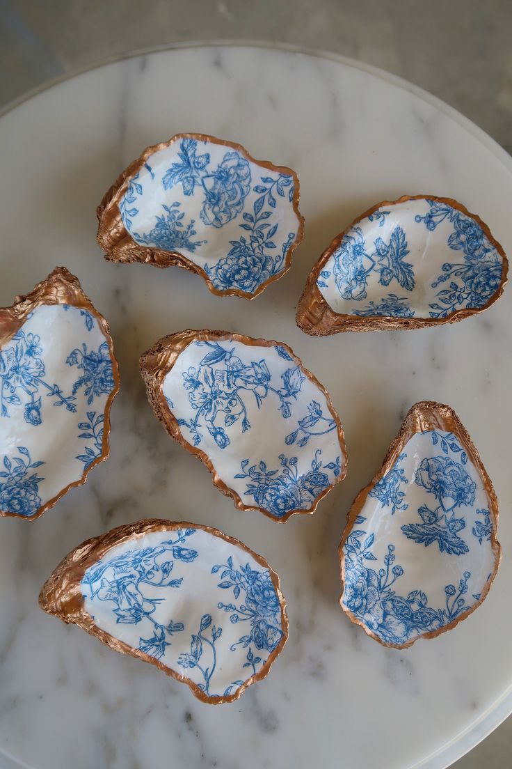 six pieces of blue and white porcelain on a marble plate