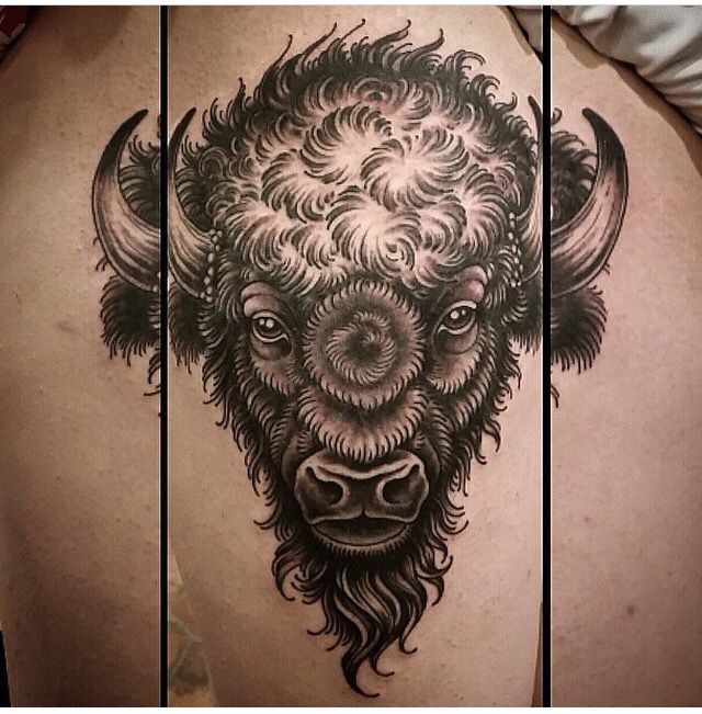 a bison tattoo on the back of a man