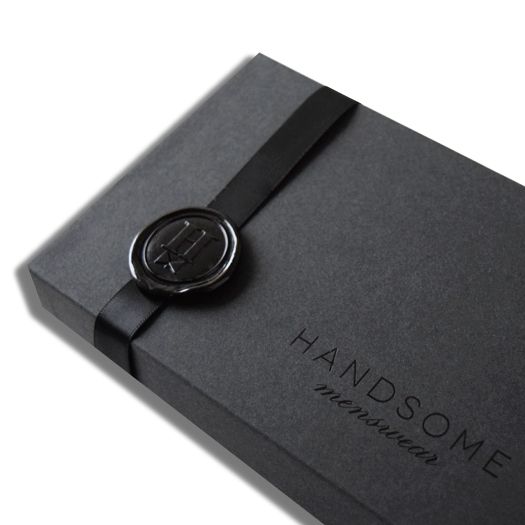 a black box with a button on the front and bottom that says handsome written in it