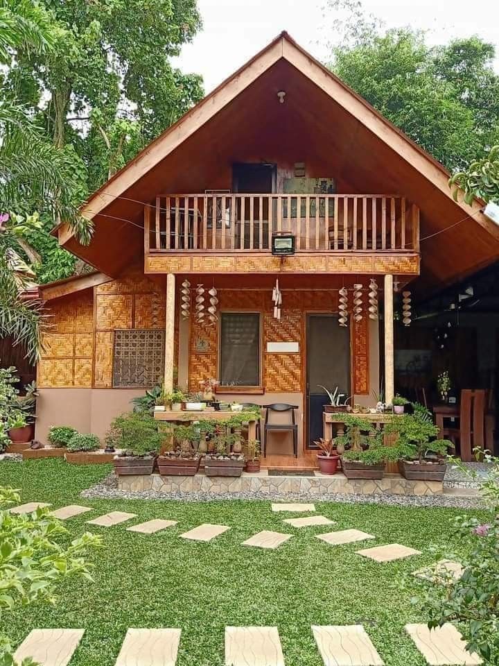 a small wooden house sitting on top of a lush green field