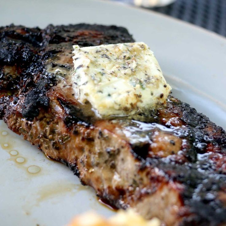 grilled meat and cheese on a white plate