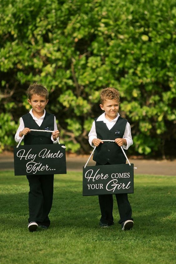 two young boys holding up signs that say they are going to get married