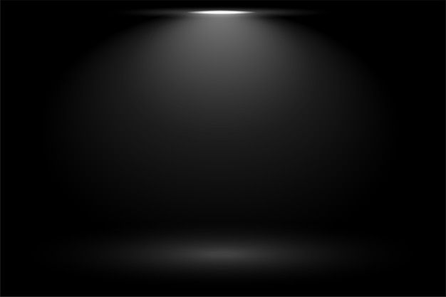 an empty black room with light coming from the ceiling and floor to the right side