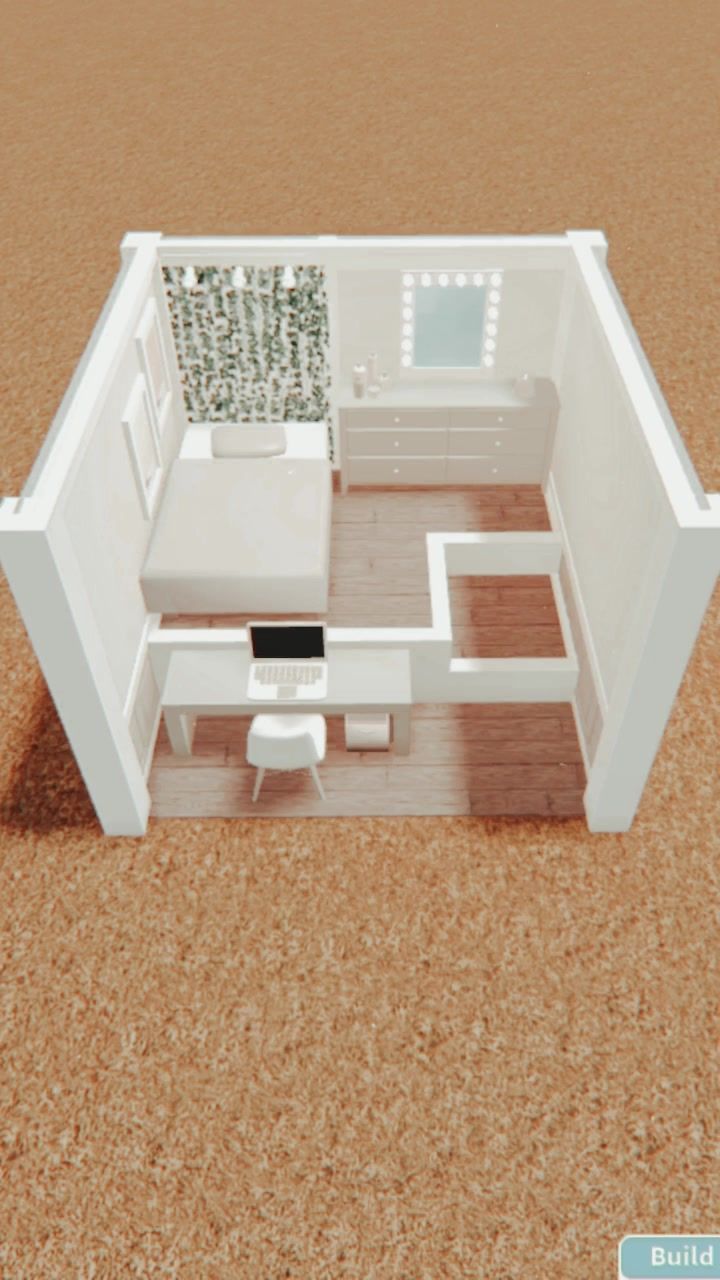 a small white house sitting on top of a brown floor