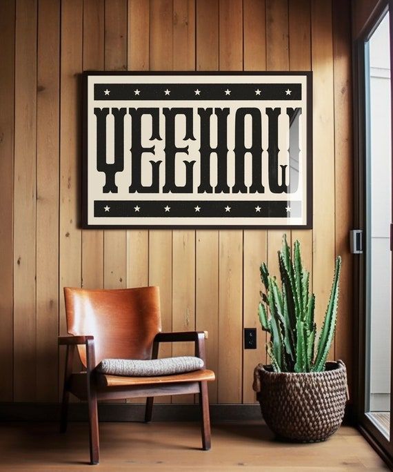 a wooden chair sitting next to a potted plant on top of a hard wood floor