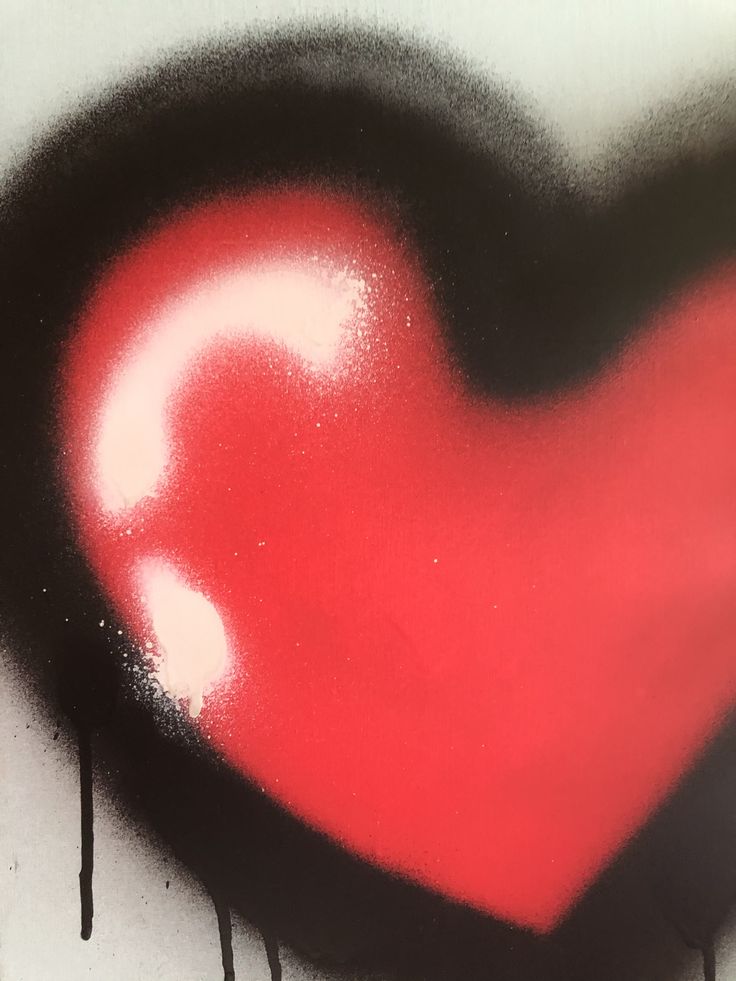 a red heart painted on the side of a wall