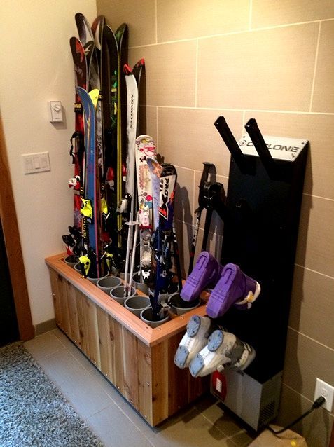 the skis are lined up on the shelf in the room next to the door