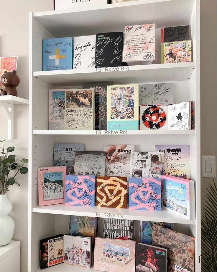 a white book shelf filled with lots of books