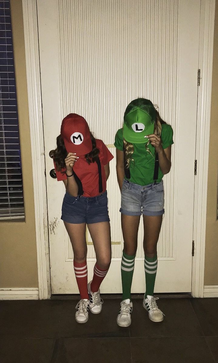 two girls dressed in costumes standing next to each other