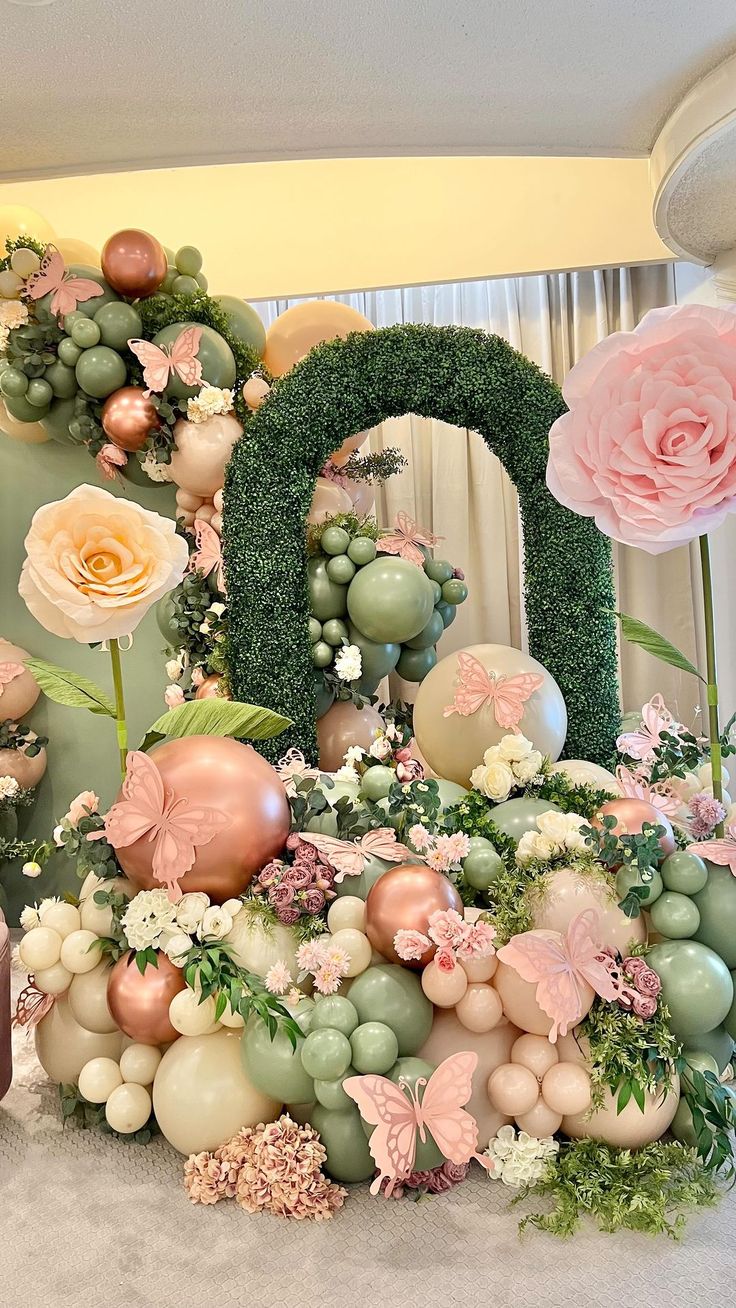 there is a large number made out of balloons and flowers on the table with pink roses