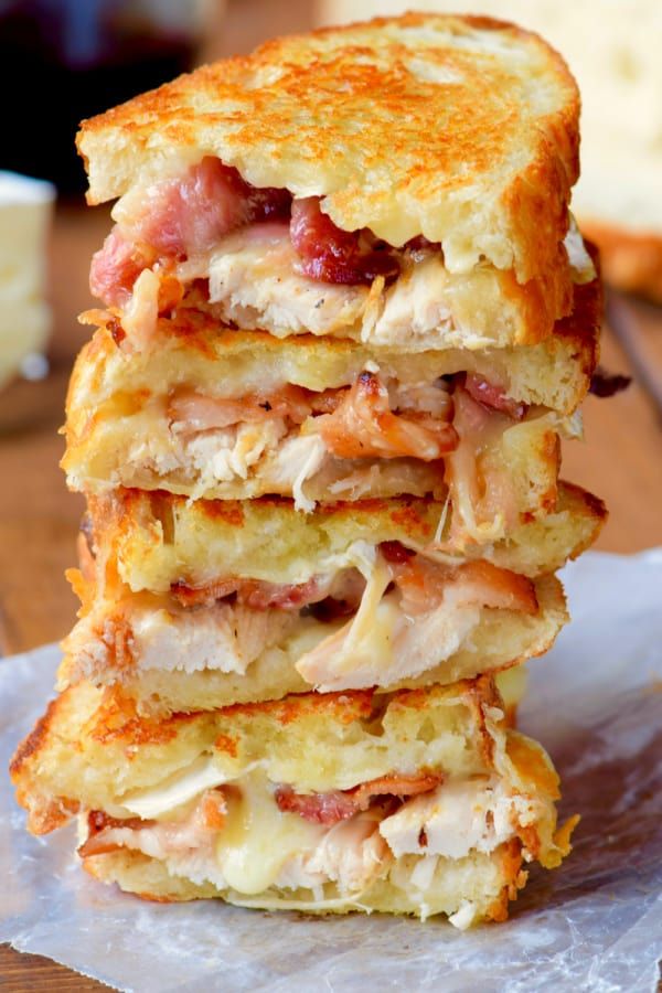 three sandwiches stacked on top of each other with meat and cheese in between the two halves