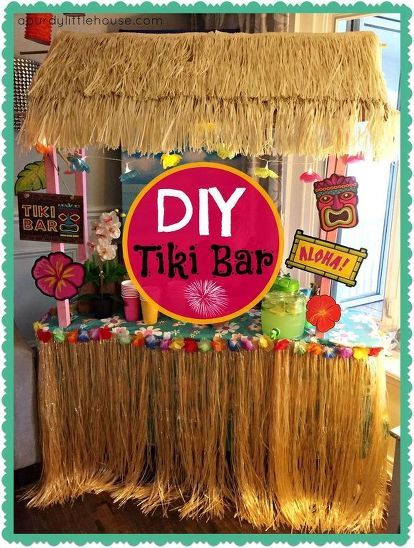 a tiki bar is decorated with grass and straw fringes for the table top