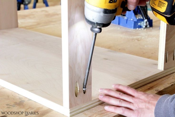 a person using a drill to cut wood