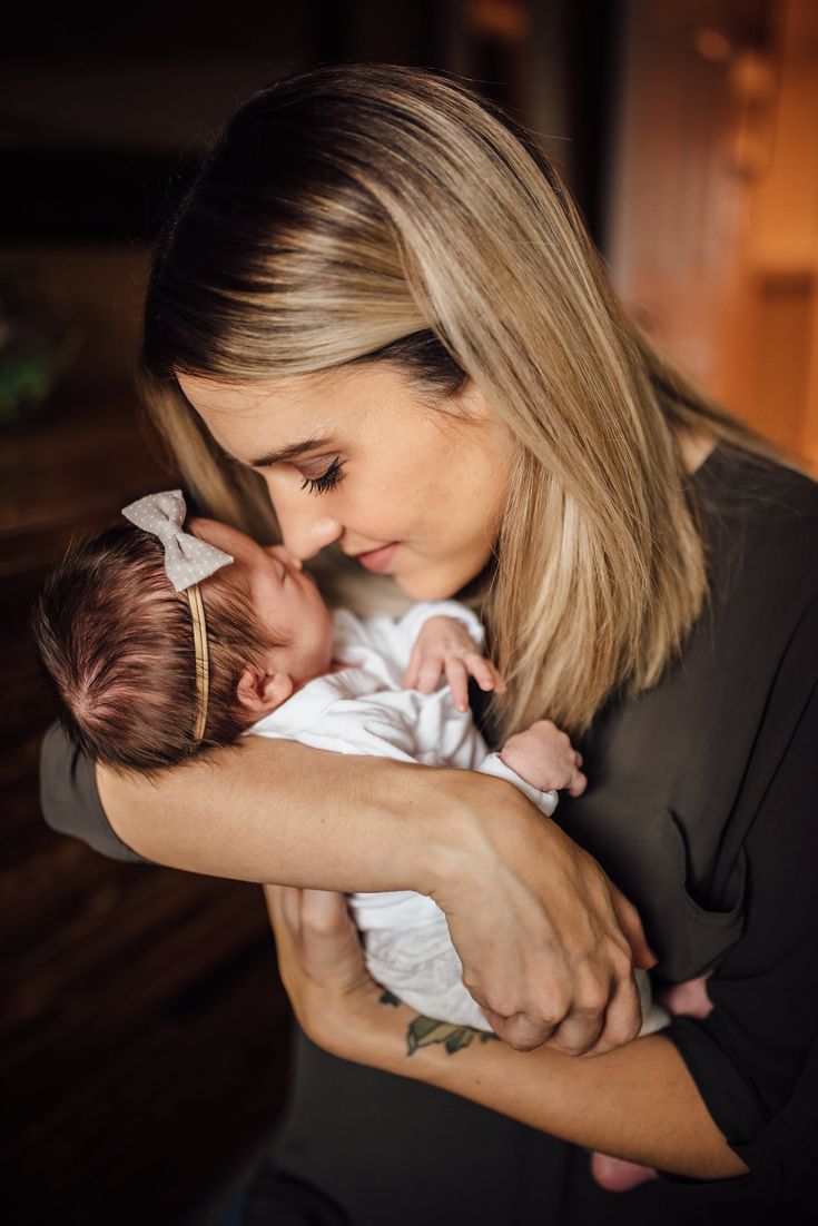 a woman holding a baby in her arms