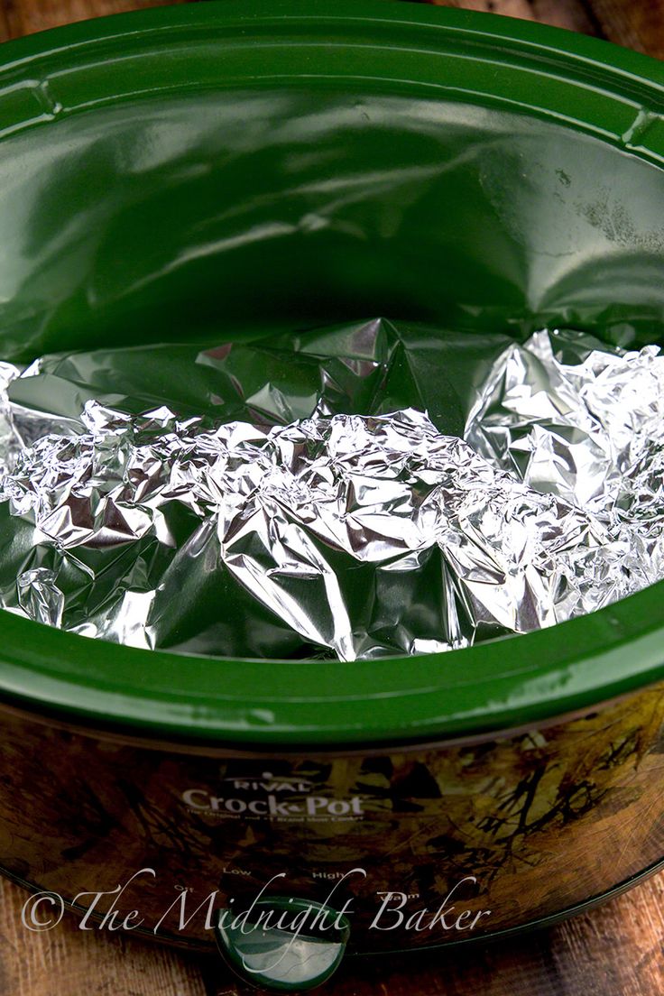 aluminum foil in a green pot on a wooden table