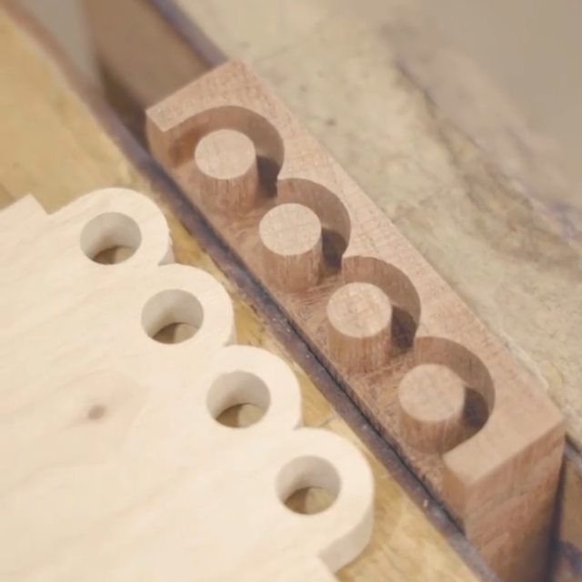 a close up of a wooden block with holes in it