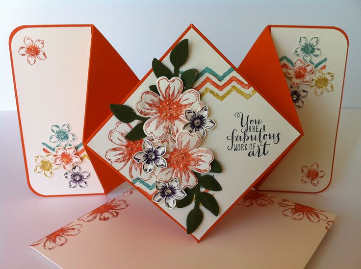 two cards with flowers on them, one is folded and the other has an envelope