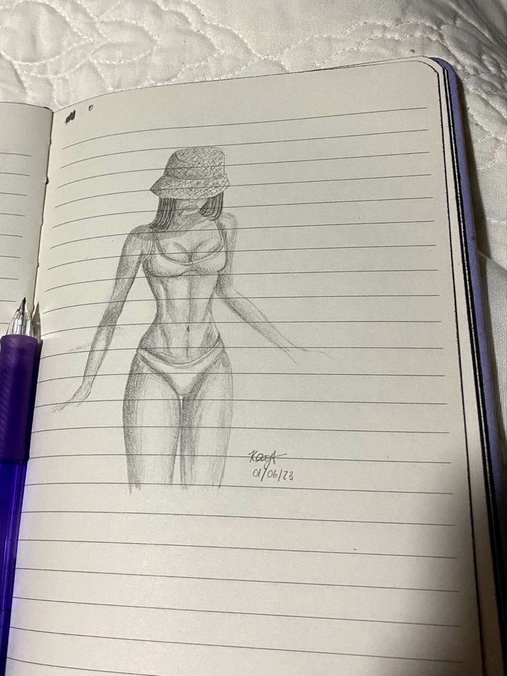 an open notebook with a drawing of a woman's torso and hat on it