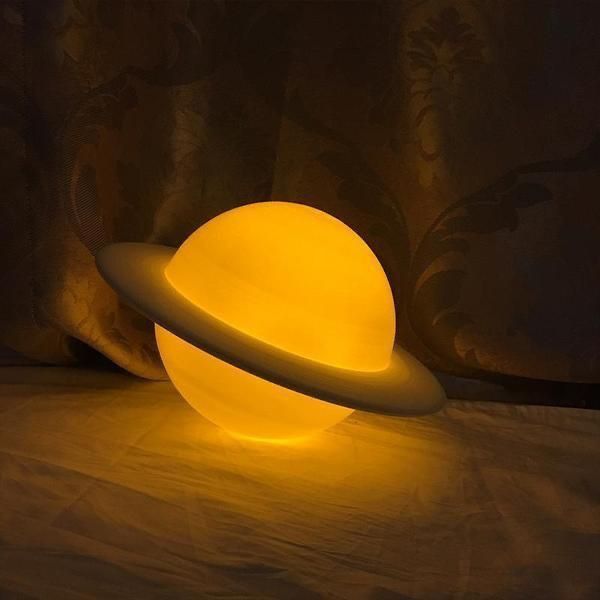 a yellow light sitting on top of a bed