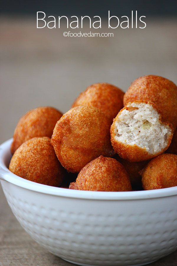 a white bowl filled with fried food on top of a wooden table and text overlay that reads banana balls