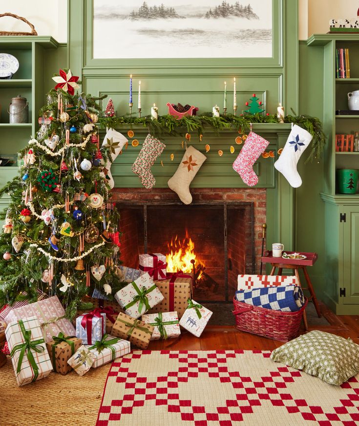 a living room decorated for christmas with presents and stockings on the fireplace mantels